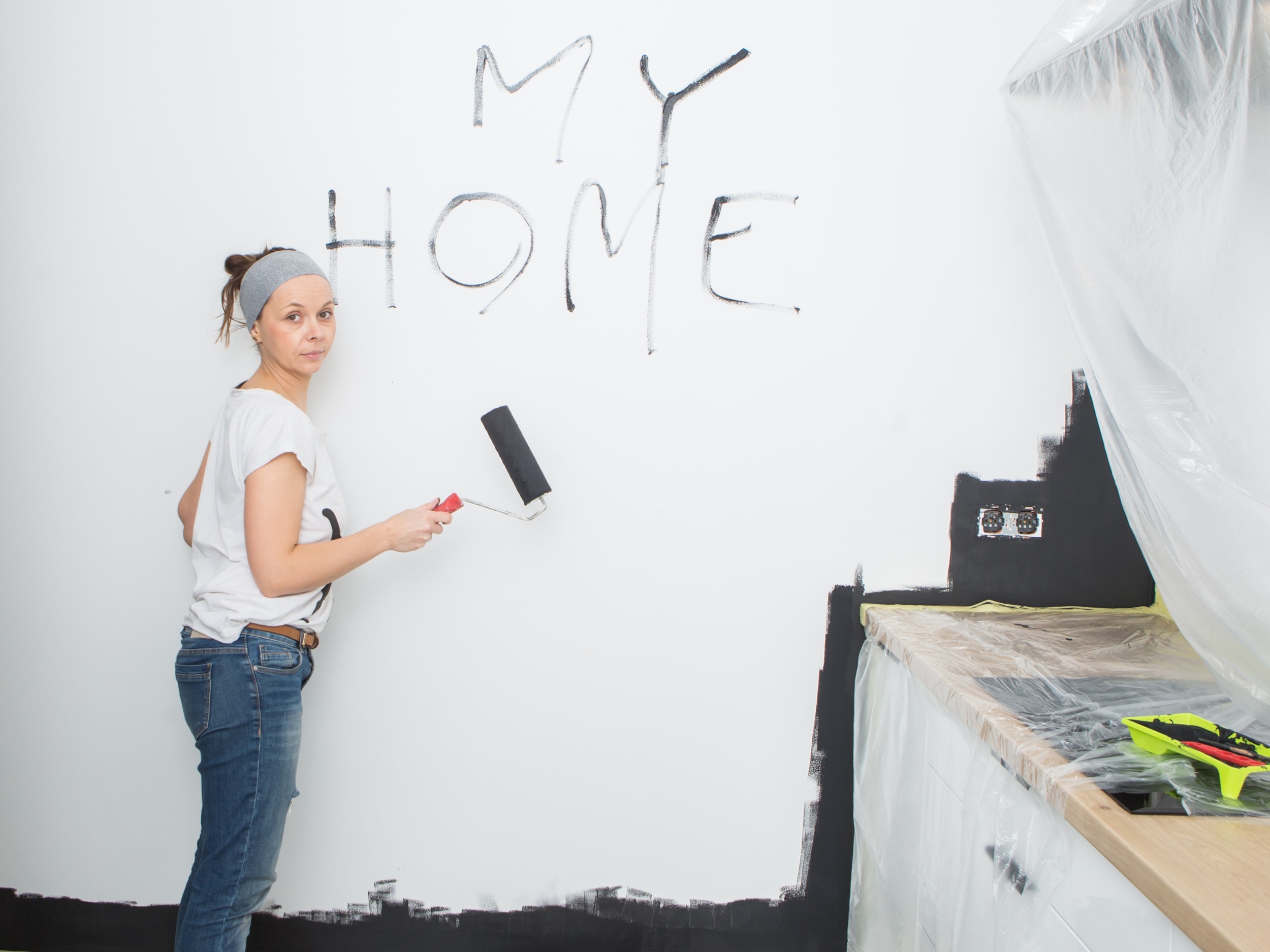 02 woman-is-writing-wall-my-house-woman-is-painting-wall-with-black-paint.jpg