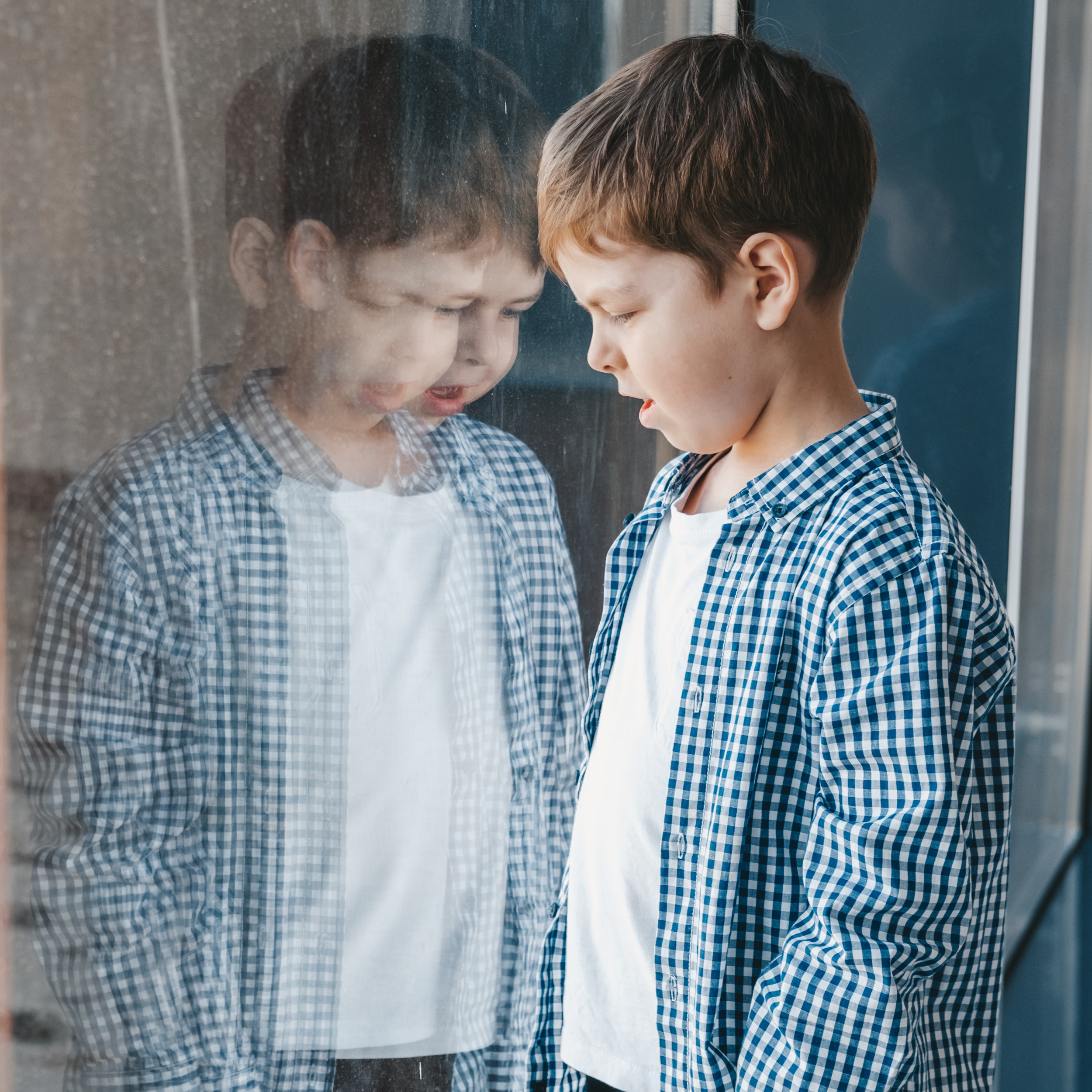 02 boy-shirt-looks-out-window-reflection-boy-window-light-dark-side-child-emotions-children.jpg