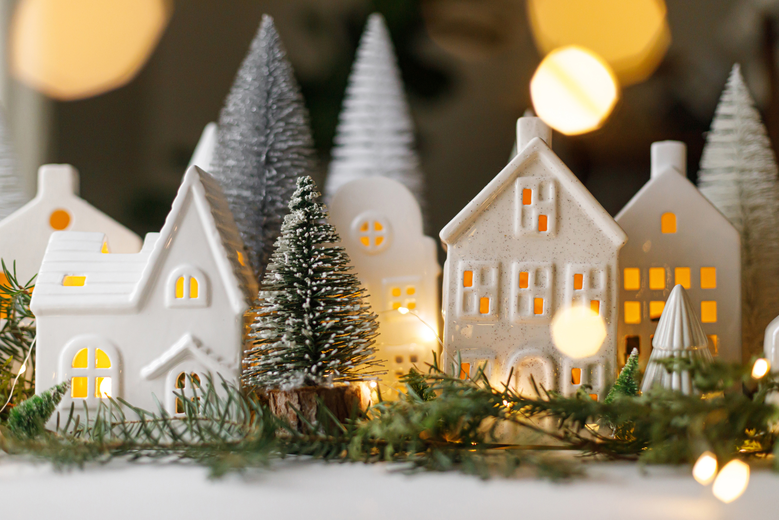 1 merry-christmas-stylish-christmas-miniature-holiday-village-with-houses-trees-fir-branches-golden-lights-bokeh-evening-room-atmospheric-magical-scene-christmas-holiday-banner.jpg