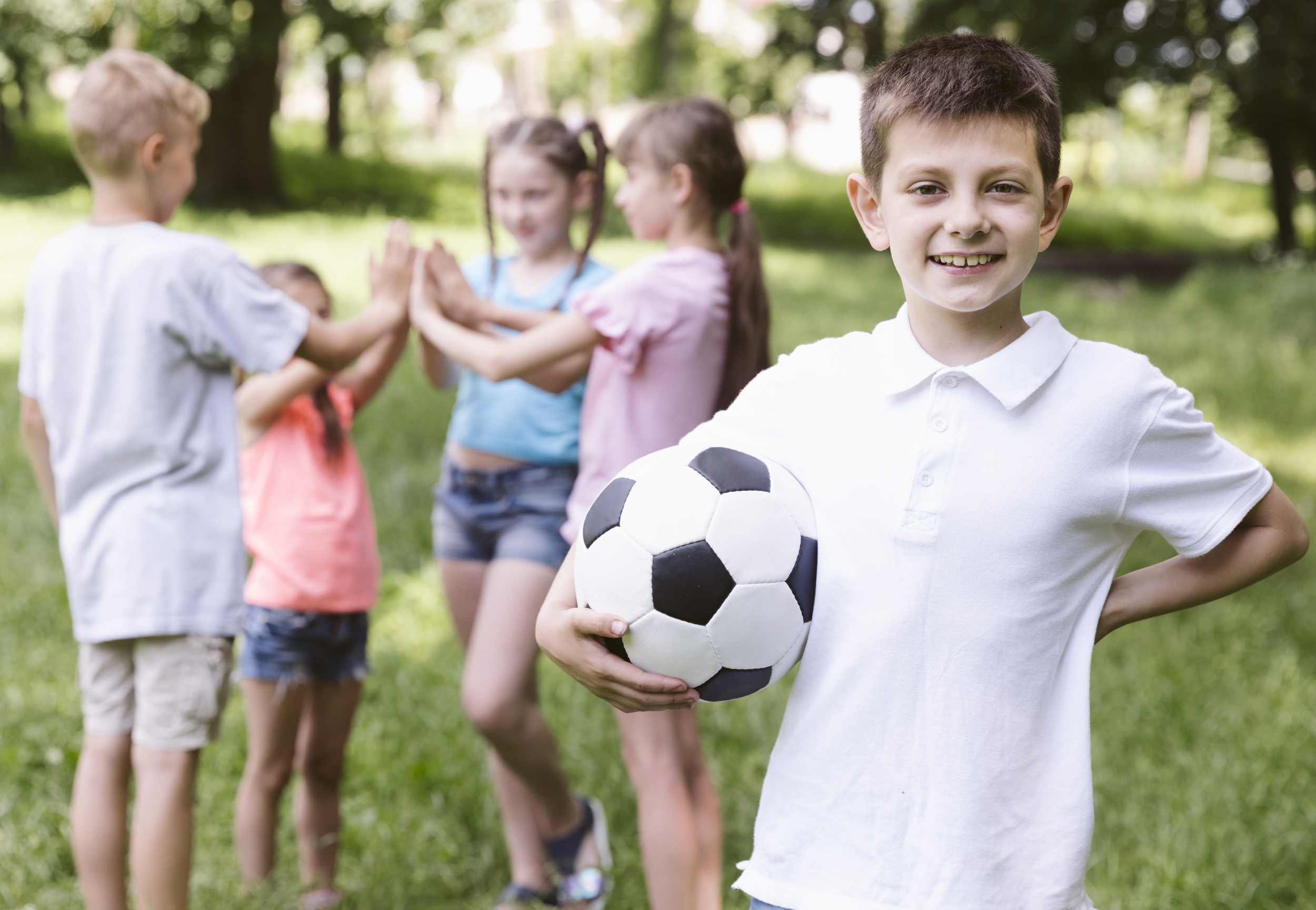01 front-view-boy-holding-football-ball.jpg