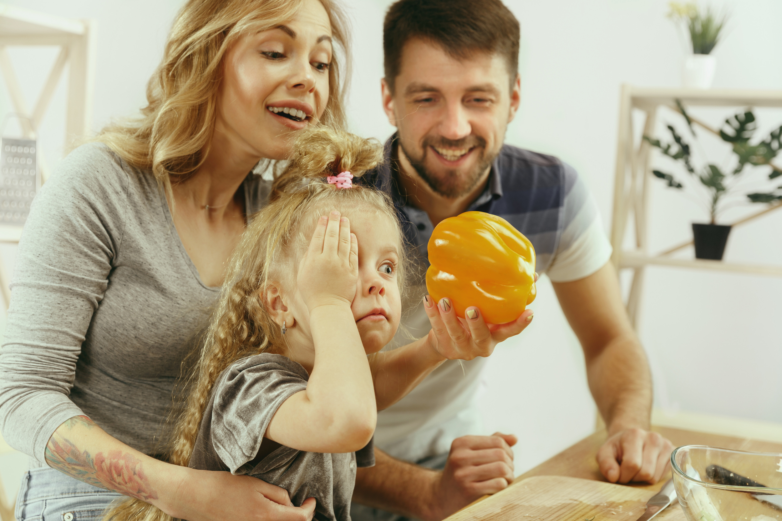 cute-little-girl-her-beautiful-parents-are-cutting-vegetables.jpg