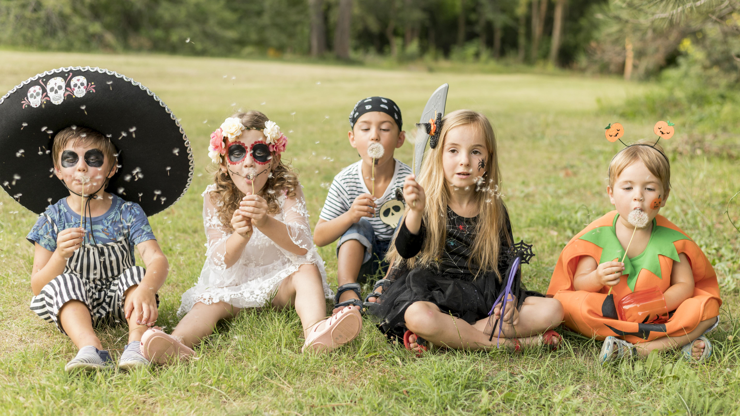 1 kids-costumated-halloween-sitting-grass.jpg 1 kids-costumated-halloween-sitting-grass.jpg