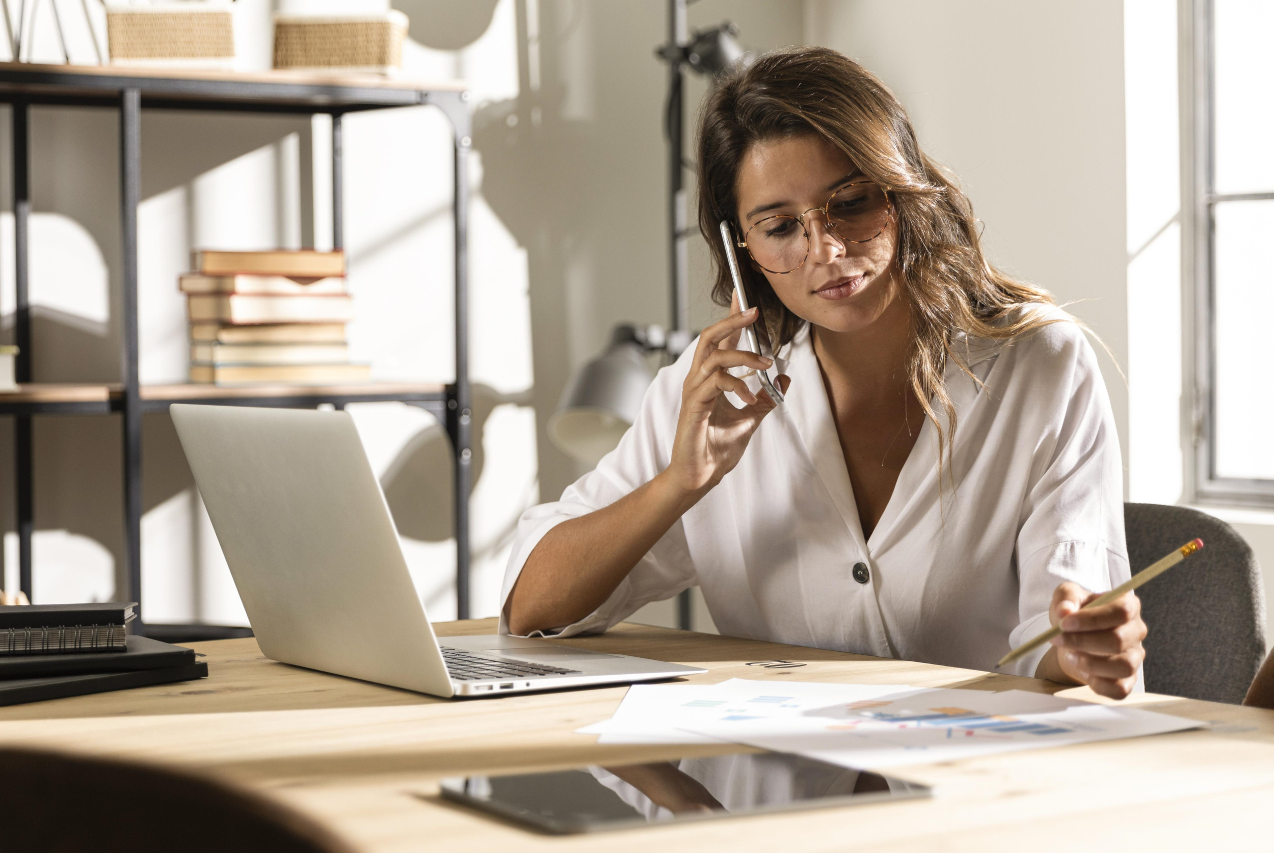 4 mid-shot-woman-talking-phone-table.jpg